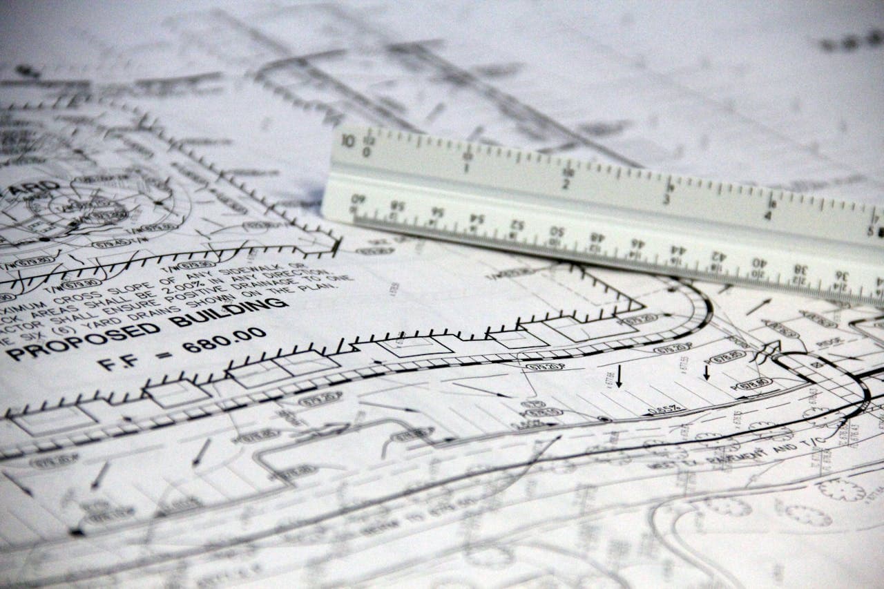 A white ruler resting on printed paper
