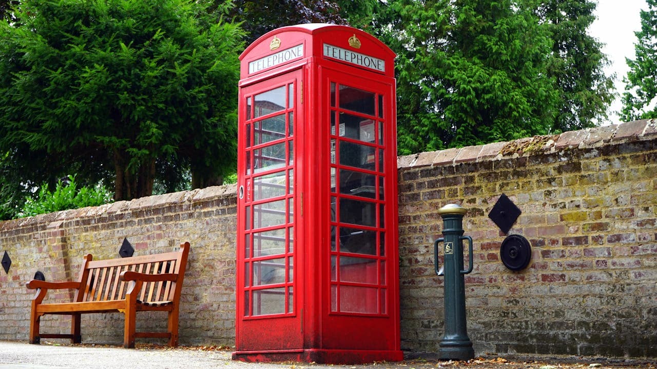 A red telephone box on a UK street